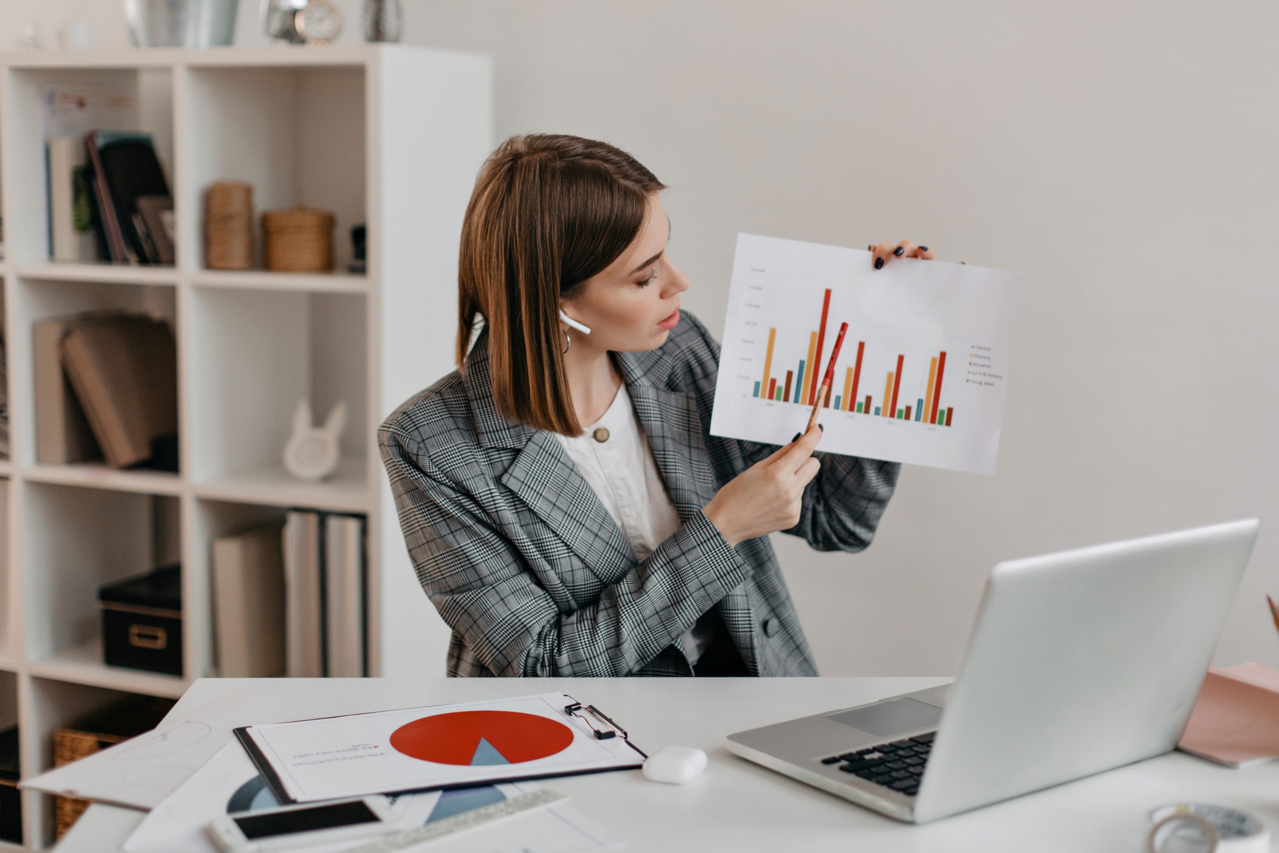 A businessperson analyzing a detailed market feasibility report with data charts and graphs to make an informed decision