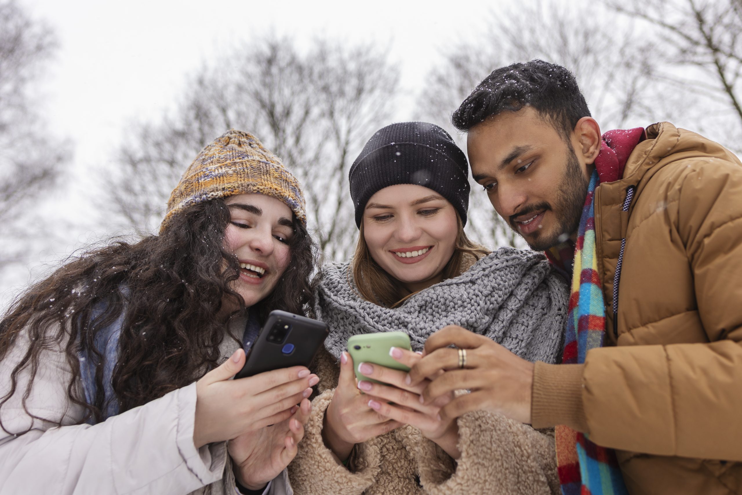 A person in a retail store comparing two different modern smartphones, representing the consumer decision-making process.
